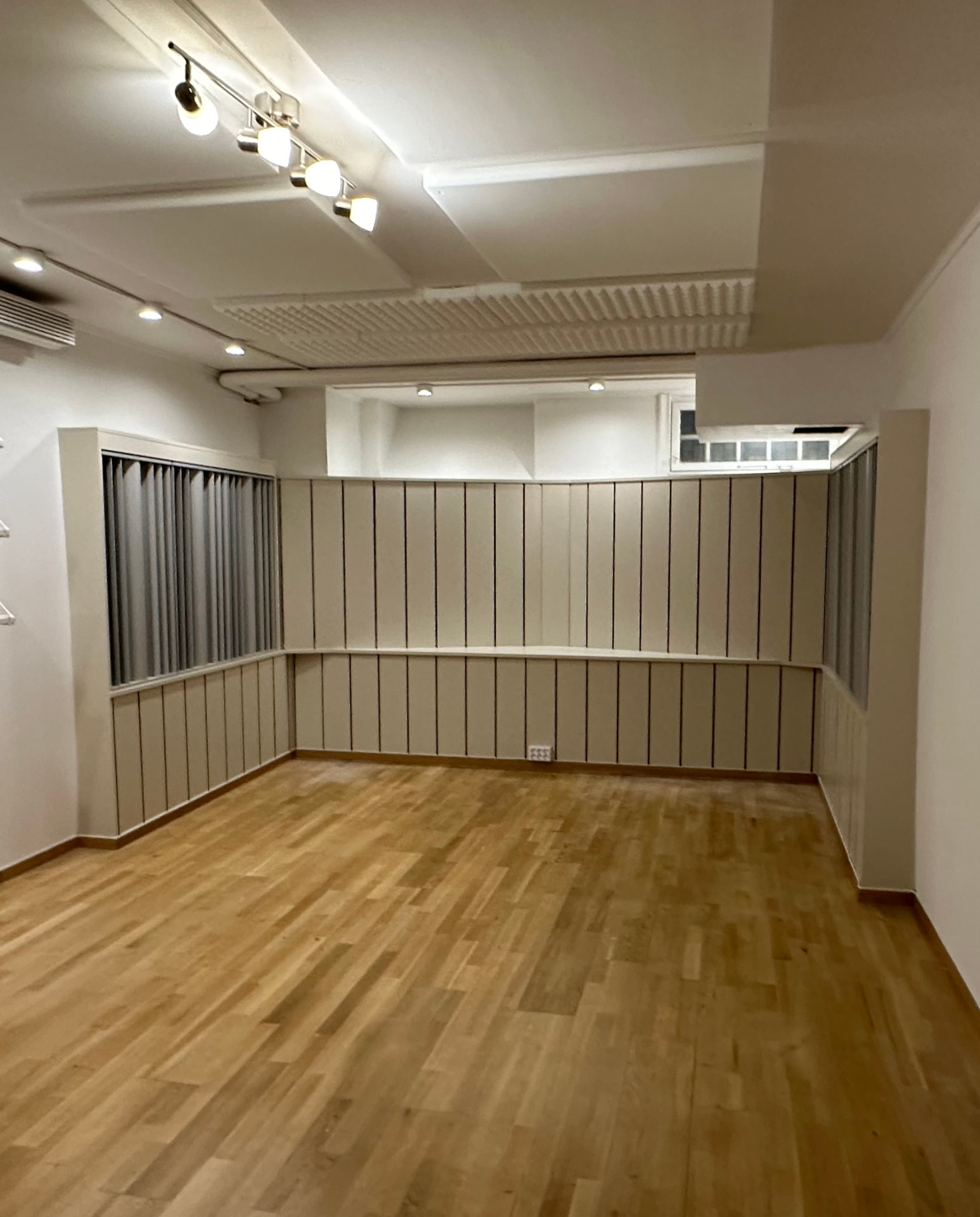 Färdigbyggd studio med platsbyggd akustikpanel, ljussättning och trägolv